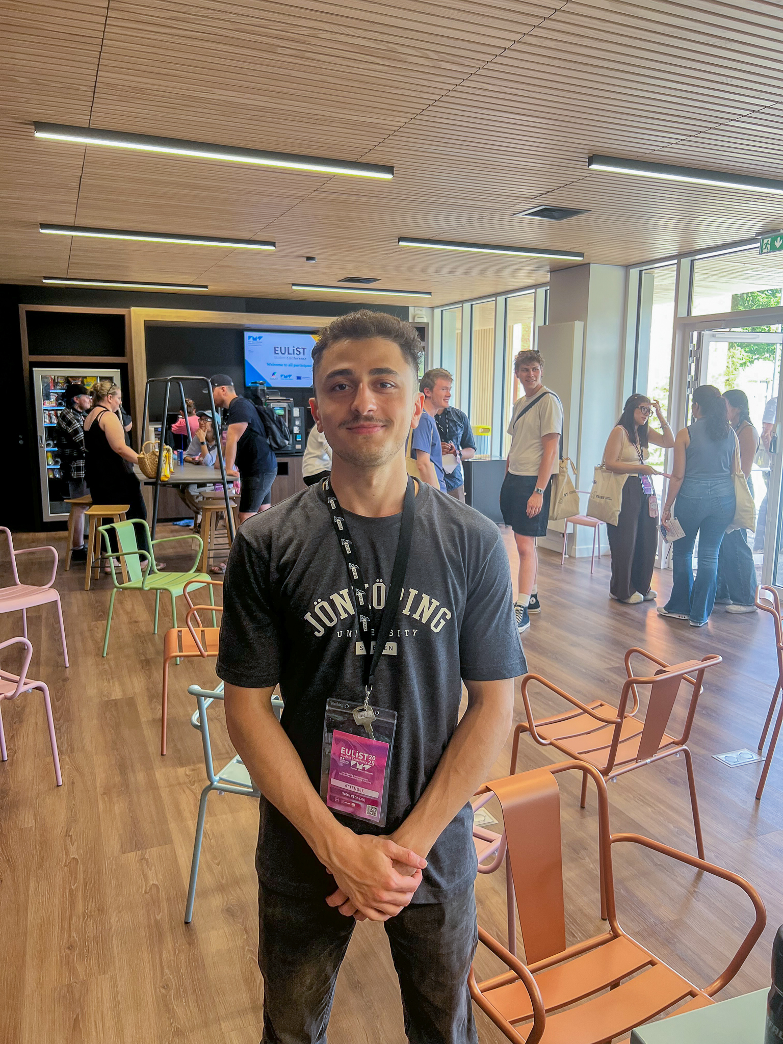 JU student looking into the camera at a conference
