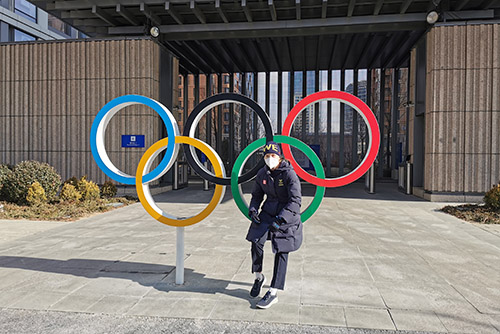 Felizia stands in front of the Olmpic rings in Beijing. 
