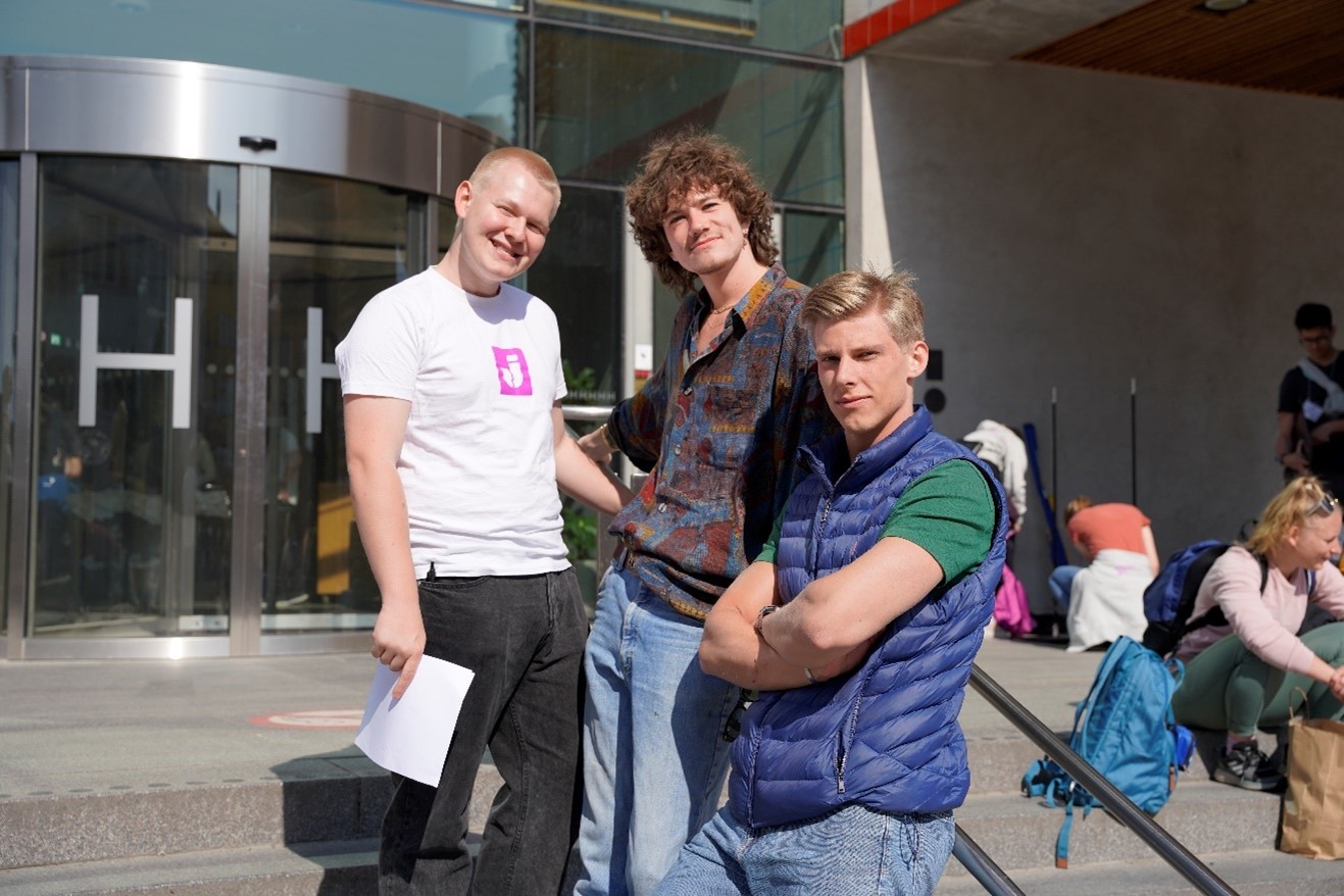 A group of men smiling towards the camera