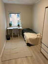 Student dorm room with bed and desk