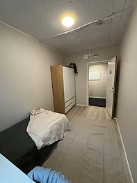 Student dorm room with bed