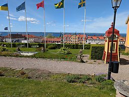 A gravel path with flag poles behind it