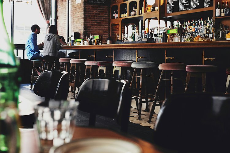A bar with chairs.